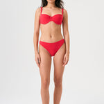 Bikini sostenible Bimba Berry. Top balconette con aro y braguita de corte clásico. Tejido reciclado ECONYL® en rojo cereza con textura atoallada. Diseño elegante y favorecedor hecho en España de forma ética.
