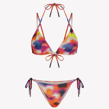 Bikini sostenible Lise Gara Calei. Top triangular multiposición y braga normal con lazada. Tejido ECOWAVE® con estampado tie-dye acuarelado y acabado lúrex. Hecho en España con producción ética.